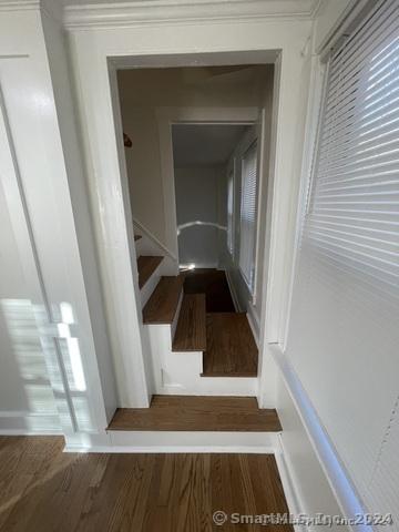 stairs with hardwood / wood-style floors