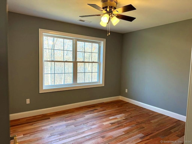 spare room featuring ceiling fan and light hardwood / wood-style floors