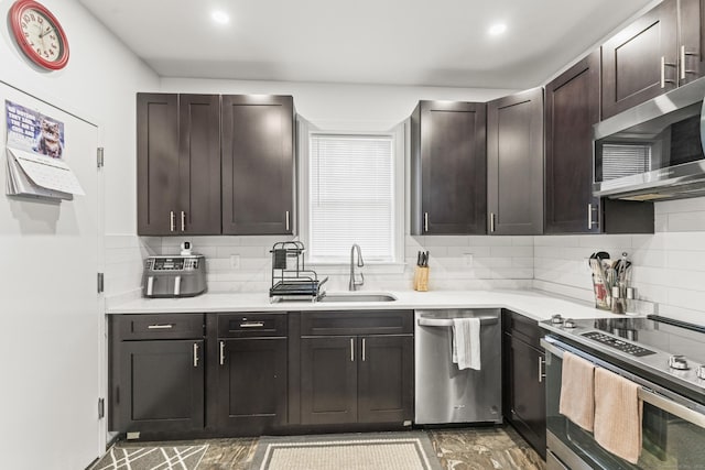23 Moore Ave, New London, CT 06320 - kitchen with appliances with stainless steel finishes, light countertops, backsplash, dark brown cabinetry, and a sink