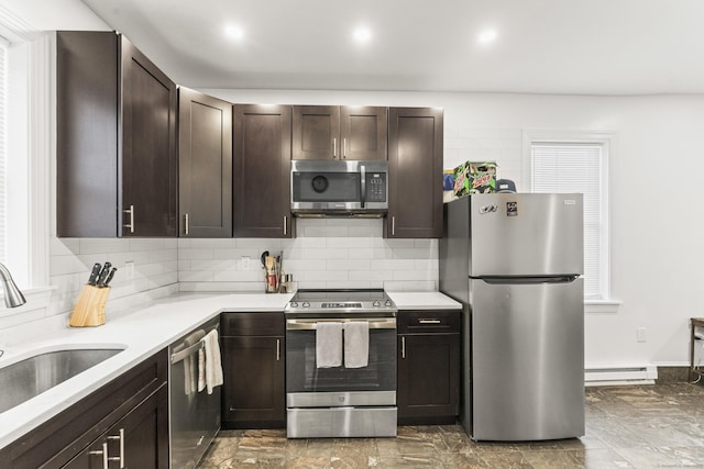 kitchen with a baseboard radiator, sink, stainless steel appliances, and dark brown cabinets