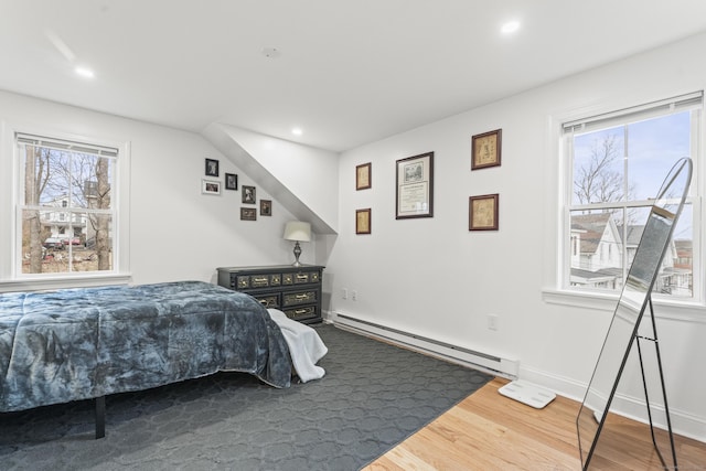 bedroom featuring a baseboard radiator and hardwood / wood-style floors