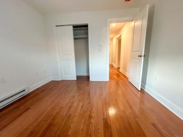 23 Moore Ave, New London, CT 06320 - unfurnished bedroom with light wood-style floors, a baseboard radiator, a closet, and baseboards