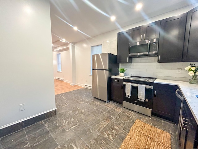 23 Moore Ave, New London, CT 06320 - kitchen with appliances with stainless steel finishes, light countertops, decorative backsplash, baseboards, and dark cabinetry
