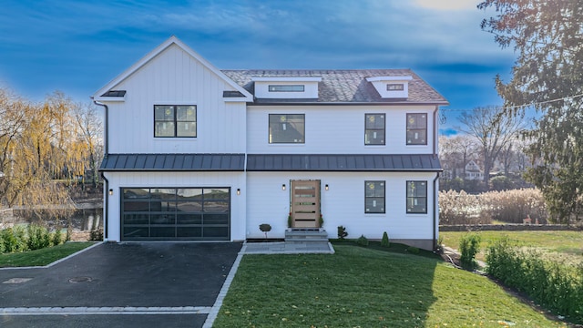 modern inspired farmhouse with a yard and a garage