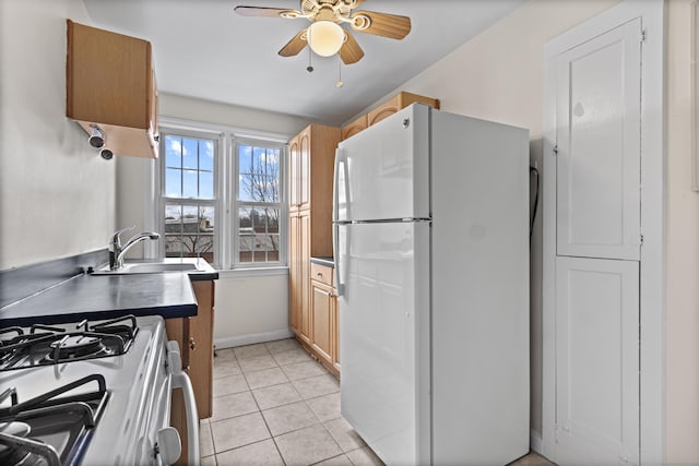 kitchen with ceiling fan, sink, light tile patterned floors, and white appliances