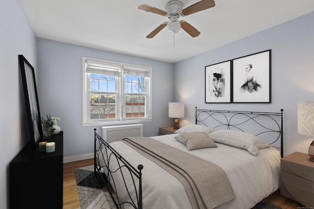 bedroom with hardwood / wood-style flooring and ceiling fan