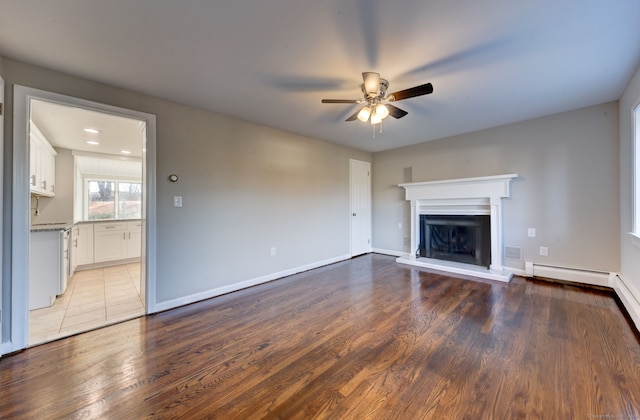 unfurnished living room with ceiling fan and light wood-type flooring