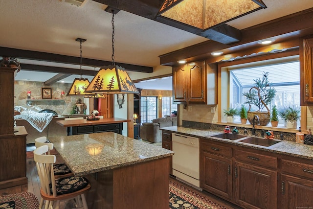 kitchen with white dishwasher, sink, light hardwood / wood-style flooring, beam ceiling, and a kitchen island