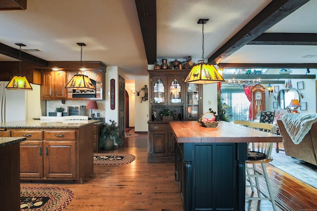 kitchen featuring beamed ceiling, dark hardwood / wood-style floors, white refrigerator, and wooden counters