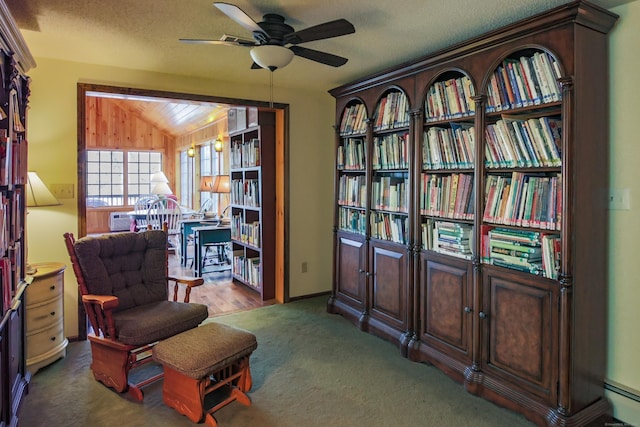 living area featuring carpet flooring, a textured ceiling, ceiling fan, and lofted ceiling