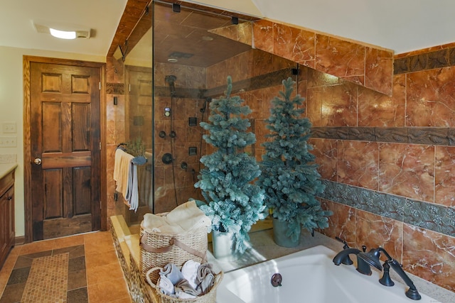 bathroom featuring shower with separate bathtub, vanity, and tile patterned floors