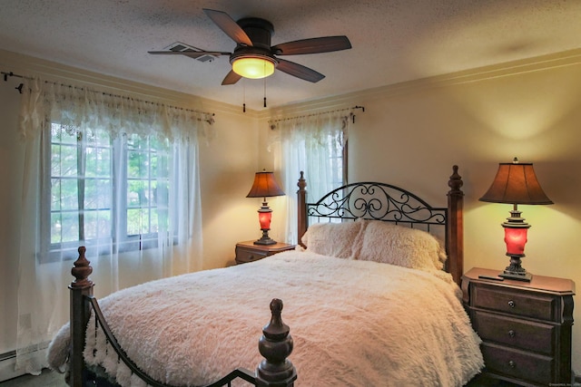 bedroom with a textured ceiling and ceiling fan