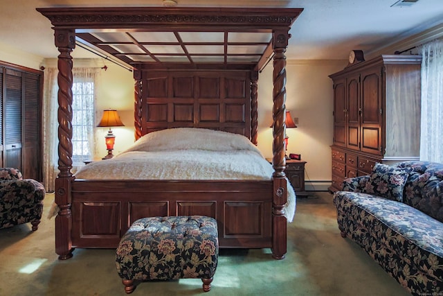 bedroom featuring carpet flooring, a closet, crown molding, and a baseboard radiator