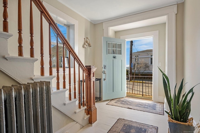 entrance foyer featuring stairs and wood finished floors
