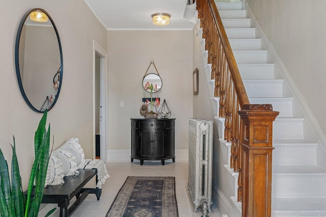 interior space featuring baseboards, stairway, and crown molding