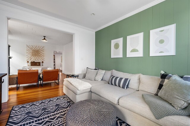 living room featuring hardwood / wood-style flooring and ornamental molding