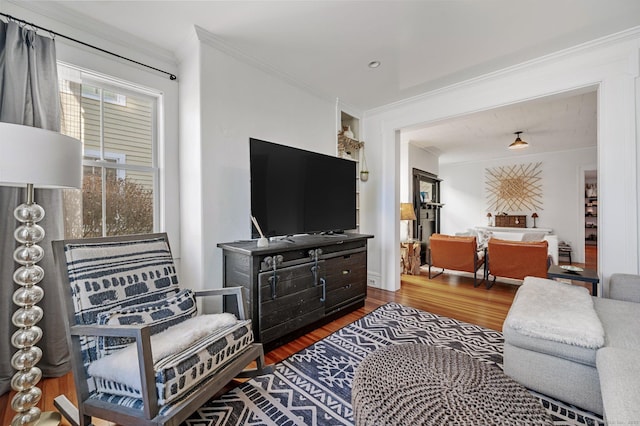 living room with ornamental molding and wood finished floors