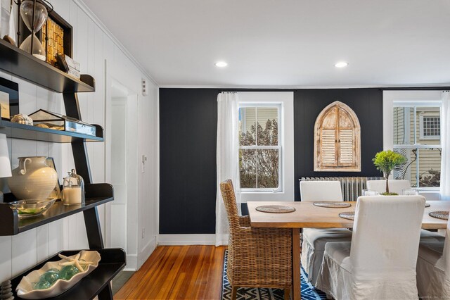 dining room featuring dark wood-type flooring and crown molding