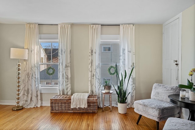 sitting room featuring baseboards and wood-type flooring