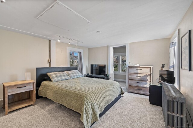 carpeted bedroom with track lighting