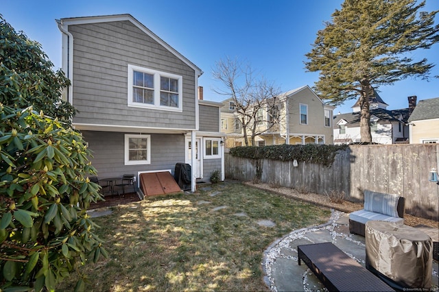 exterior space with a patio area, fence, and a lawn