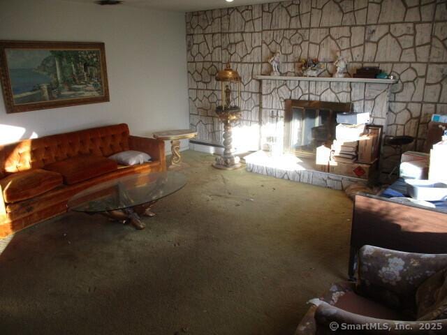 living room featuring a fireplace and carpet flooring