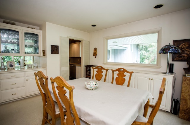 dining area featuring light colored carpet