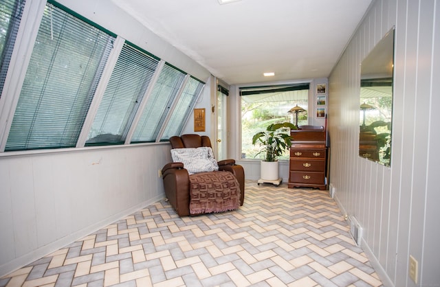 living area featuring wood walls