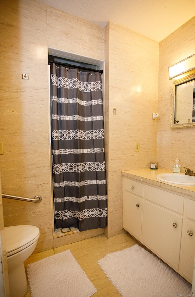 bathroom with hardwood / wood-style flooring, vanity, toilet, and walk in shower