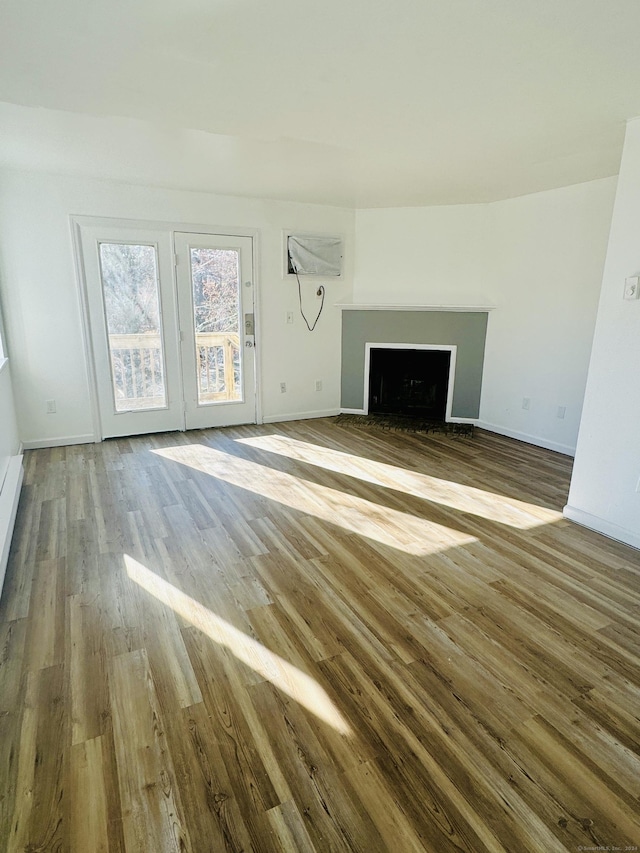 unfurnished living room with hardwood / wood-style flooring