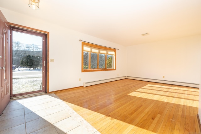 spare room with light wood-type flooring and a wealth of natural light