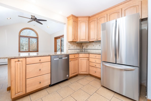 kitchen with vaulted ceiling, ceiling fan, light brown cabinetry, tasteful backsplash, and stainless steel appliances