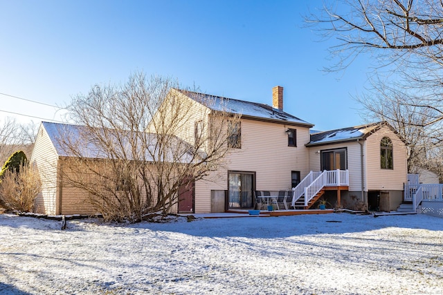 snow covered property featuring a deck