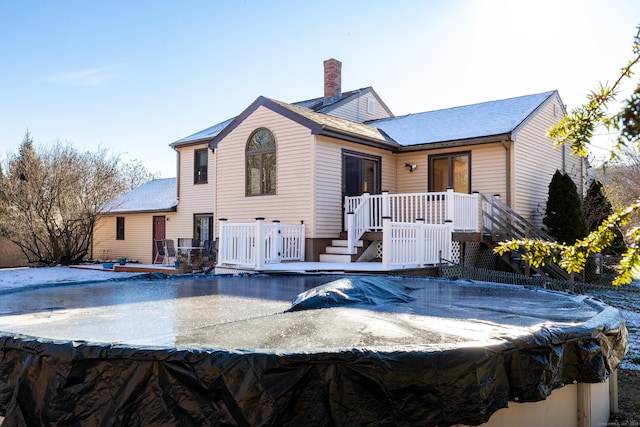 back of property with a swimming pool side deck