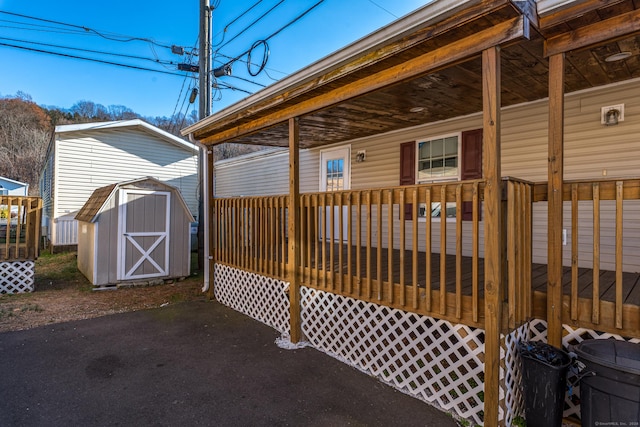 exterior space featuring covered porch and a storage shed