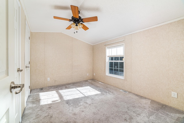 unfurnished room with light colored carpet, crown molding, ceiling fan, and lofted ceiling