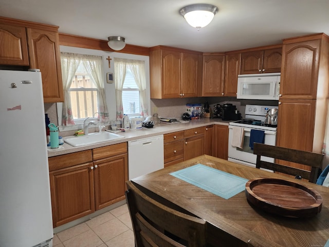 kitchen with decorative backsplash, sink, light tile patterned flooring, and white appliances