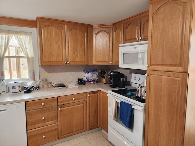 kitchen featuring light tile patterned floors and white appliances