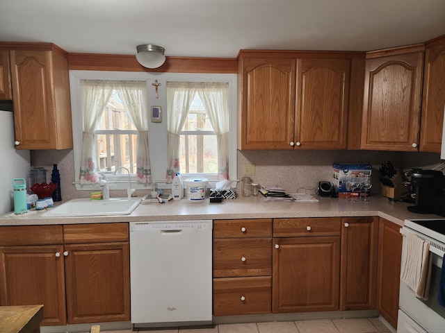 kitchen featuring light tile patterned flooring, white appliances, sink, and tasteful backsplash