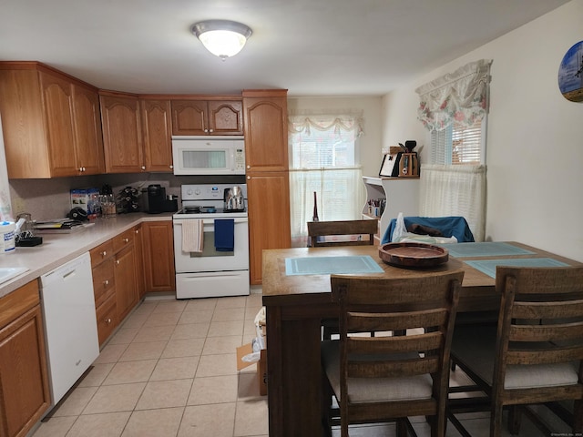 kitchen with light tile patterned flooring and white appliances