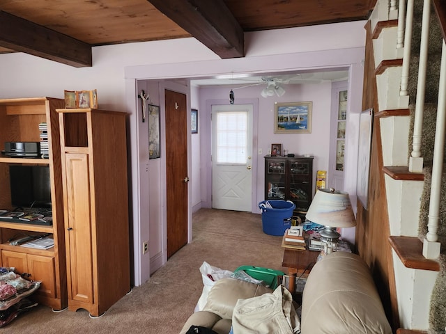 corridor featuring light carpet, beamed ceiling, and wooden ceiling