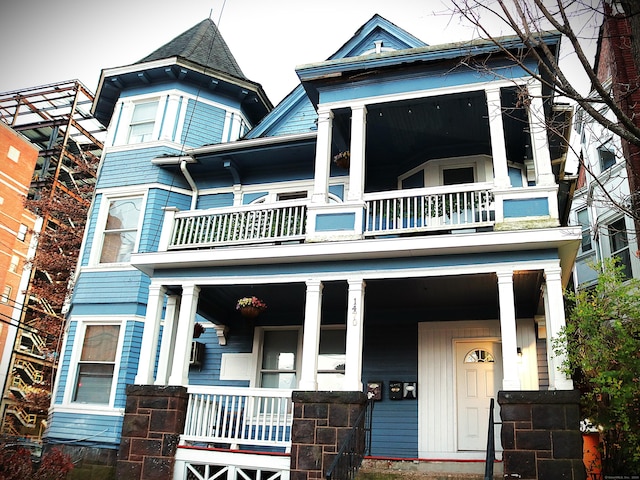 view of front of home with covered porch and a balcony