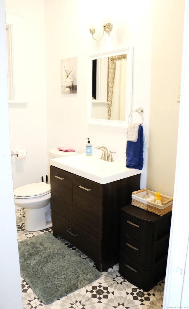 bathroom featuring vanity and toilet