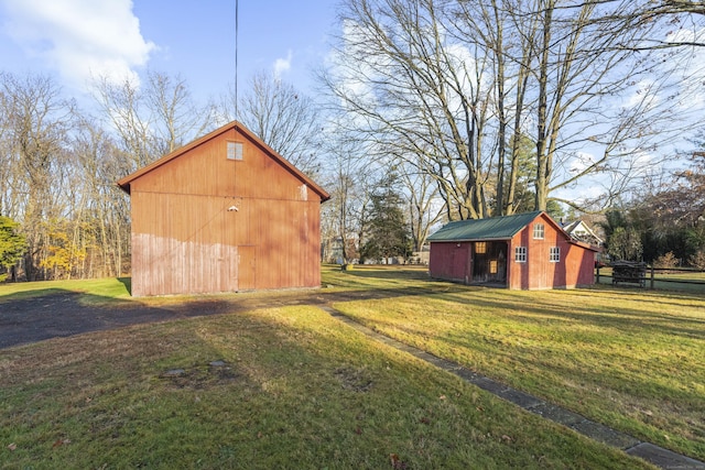 view of outbuilding featuring a lawn