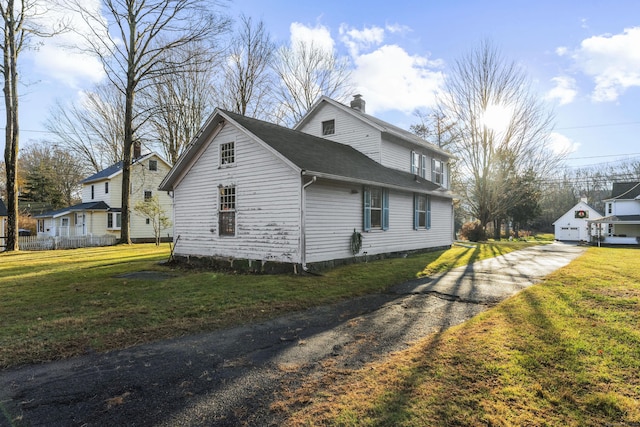 view of property exterior featuring a lawn and a garage