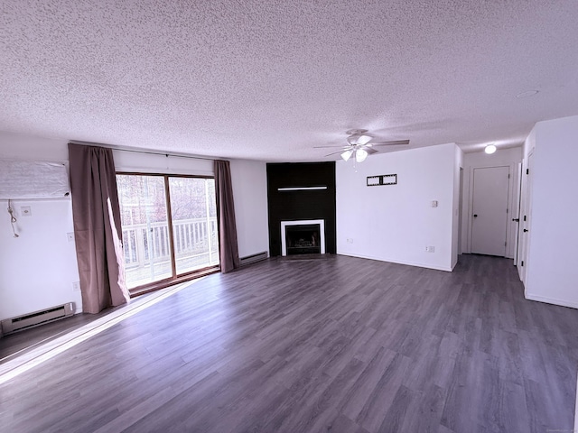 unfurnished living room with baseboard heating, dark hardwood / wood-style flooring, and a textured ceiling