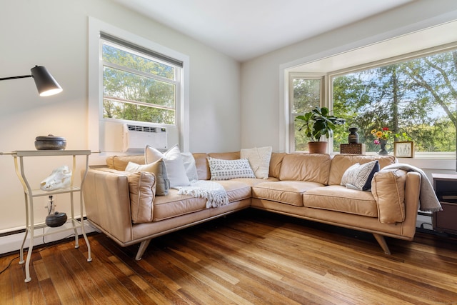 living room featuring a wealth of natural light, cooling unit, and wood-type flooring