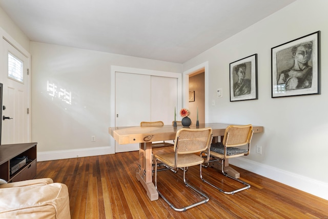 dining space with dark hardwood / wood-style flooring