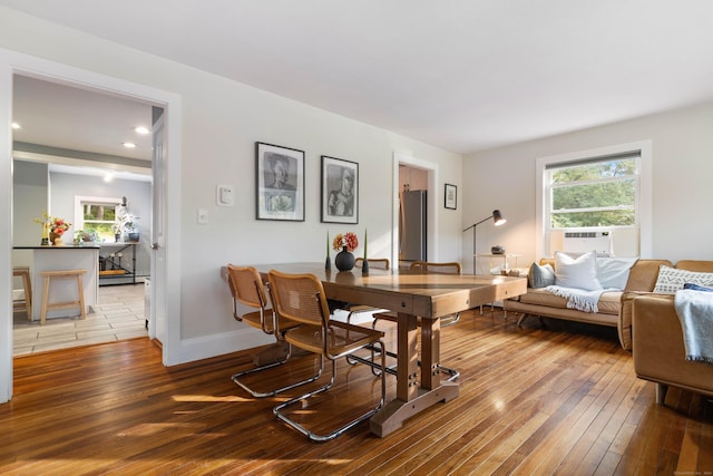 dining room with cooling unit and hardwood / wood-style flooring