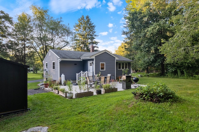 back of house with a lawn